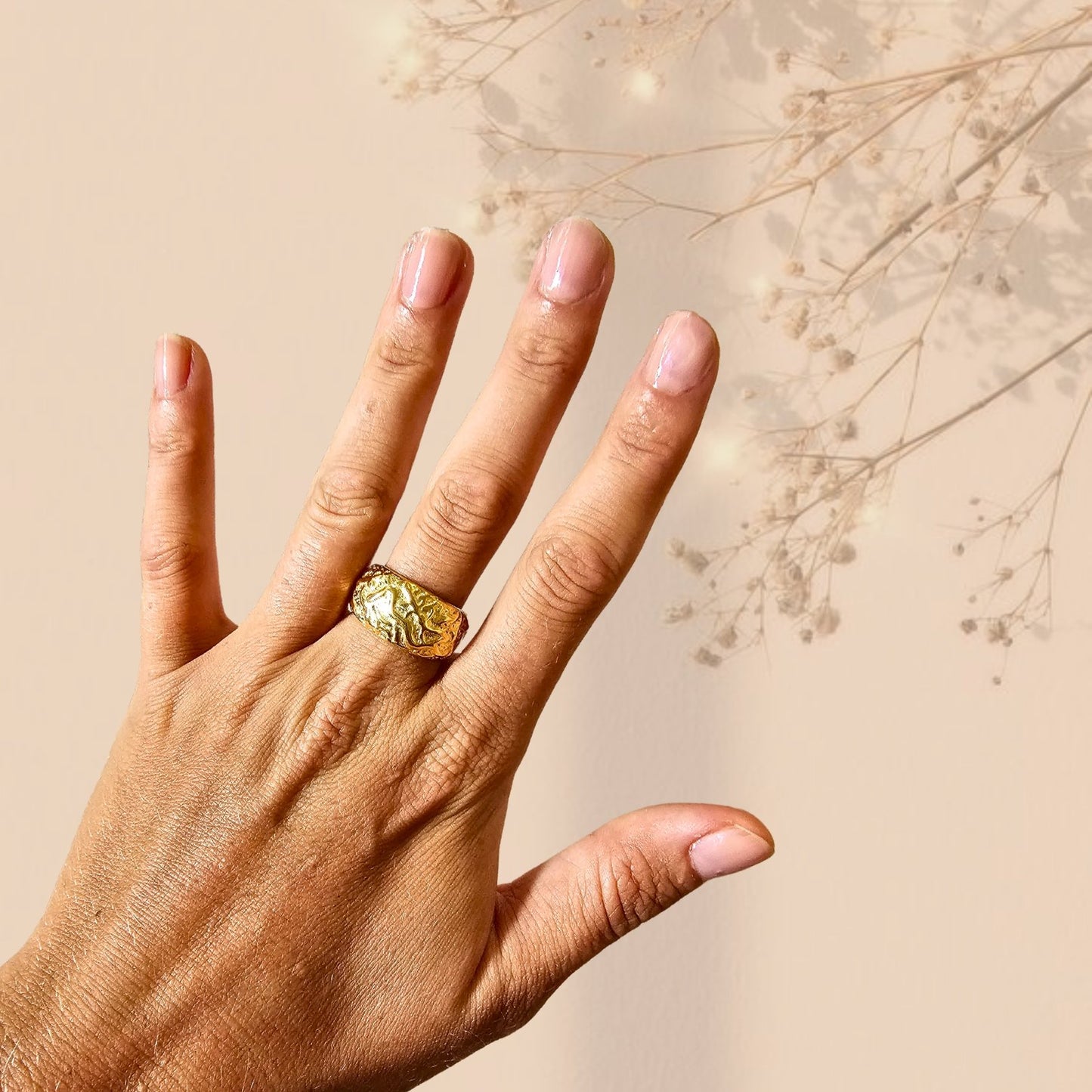 Hammered gold ring on hand